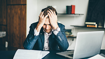 stressed man sat at desk