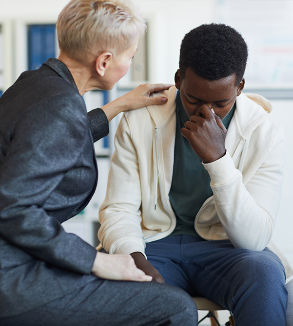 man with anxiety comforted by trauma therapist during counselling