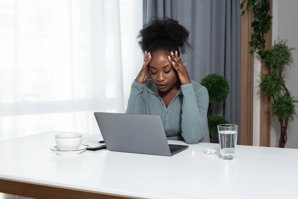 worried woman having online trauma therapy